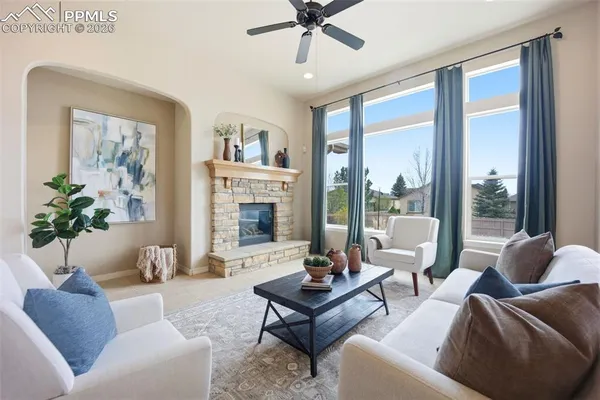 a living room with furniture and a potted plant