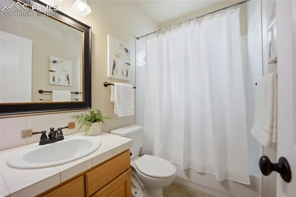 a bathroom with a sink toilet and mirror