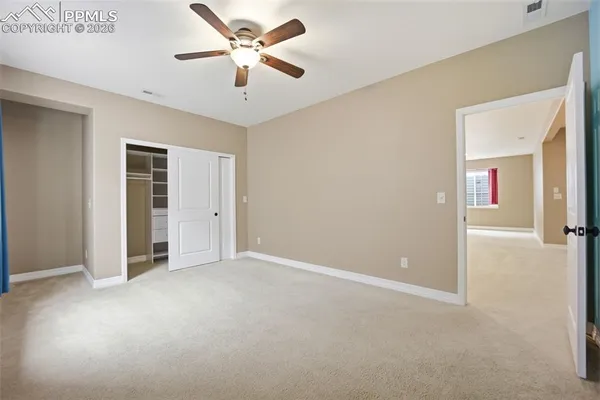 a view of an empty room with a ceiling fan