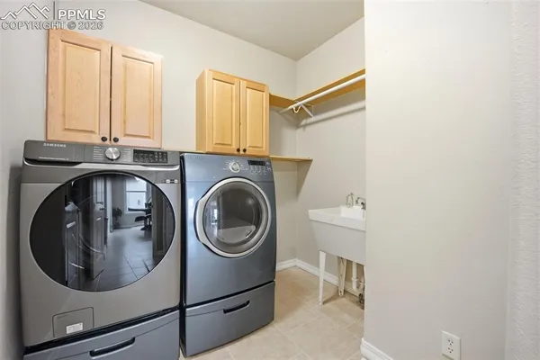 a utility room with sink dryer and washer