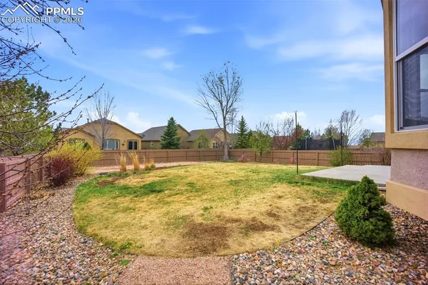 a view of yard with swimming pool and green space