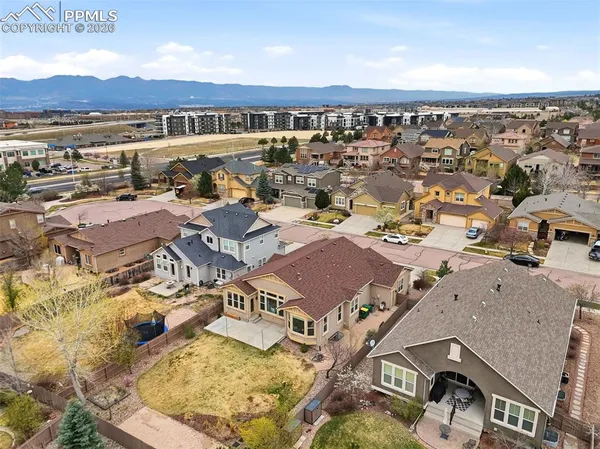 an aerial view of residential houses with outdoor space
