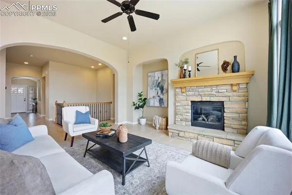 a living room with furniture and a fireplace