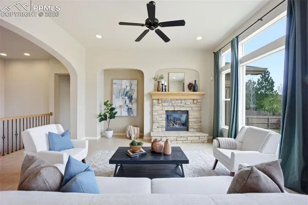 a living room with furniture and a fireplace