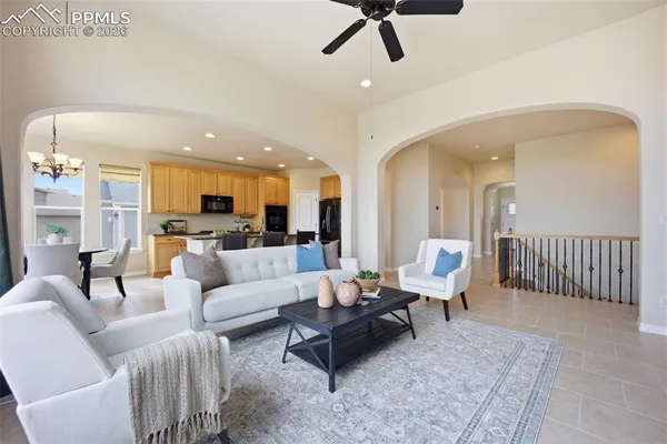 a living room with furniture and kitchen view