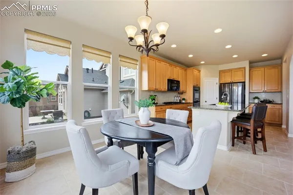 a view of a dining room with furniture and a chandelier