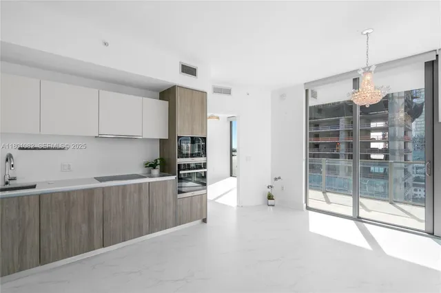 a bathroom with a tub shower sink and mirror