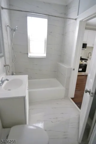 a bathroom with a bathtub and a sink