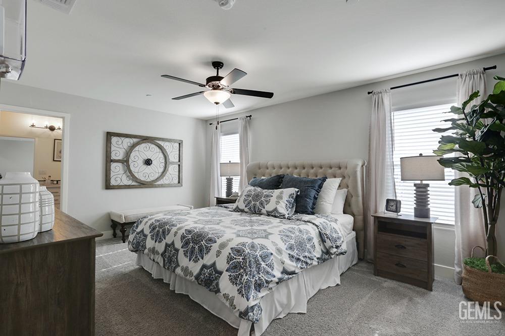 Undisclosed Address Bakersfield, CA 93314 - Photo 6 of 13 a bedroom with a large bed and a chandelier