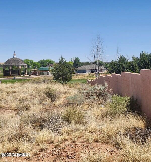 2642 West Foothill Circle, Unit 13 Snowflake, AZ 85937 - Photo 17 of 19 a view of a dry yard with wooden fence