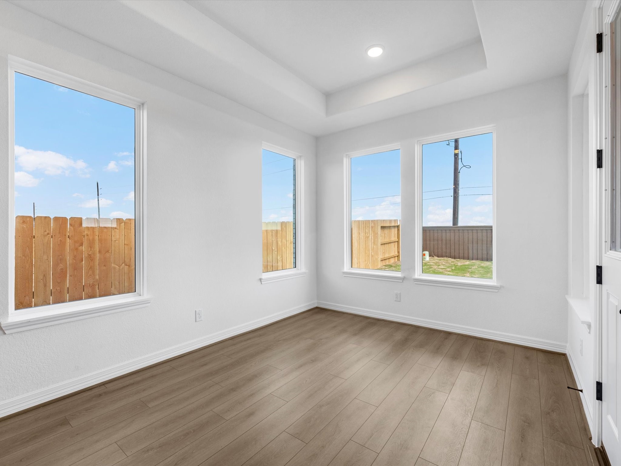 511 Selaura Street Rosenberg, TX 77471 - Photo 11 of 30 a view of an empty room with wooden floor and a window
