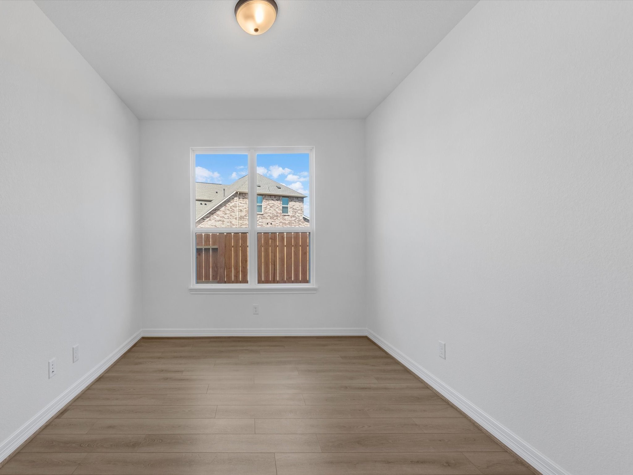 511 Selaura Street Rosenberg, TX 77471 - Photo 12 of 30 wooden floor in an empty room with a window