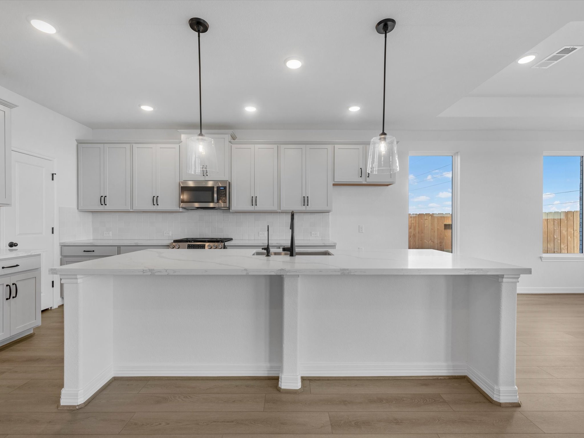 511 Selaura Street Rosenberg, TX 77471 - Photo 3 of 30 a kitchen with stainless steel appliances granite countertop a sink a stove a refrigerator and white cabinets
