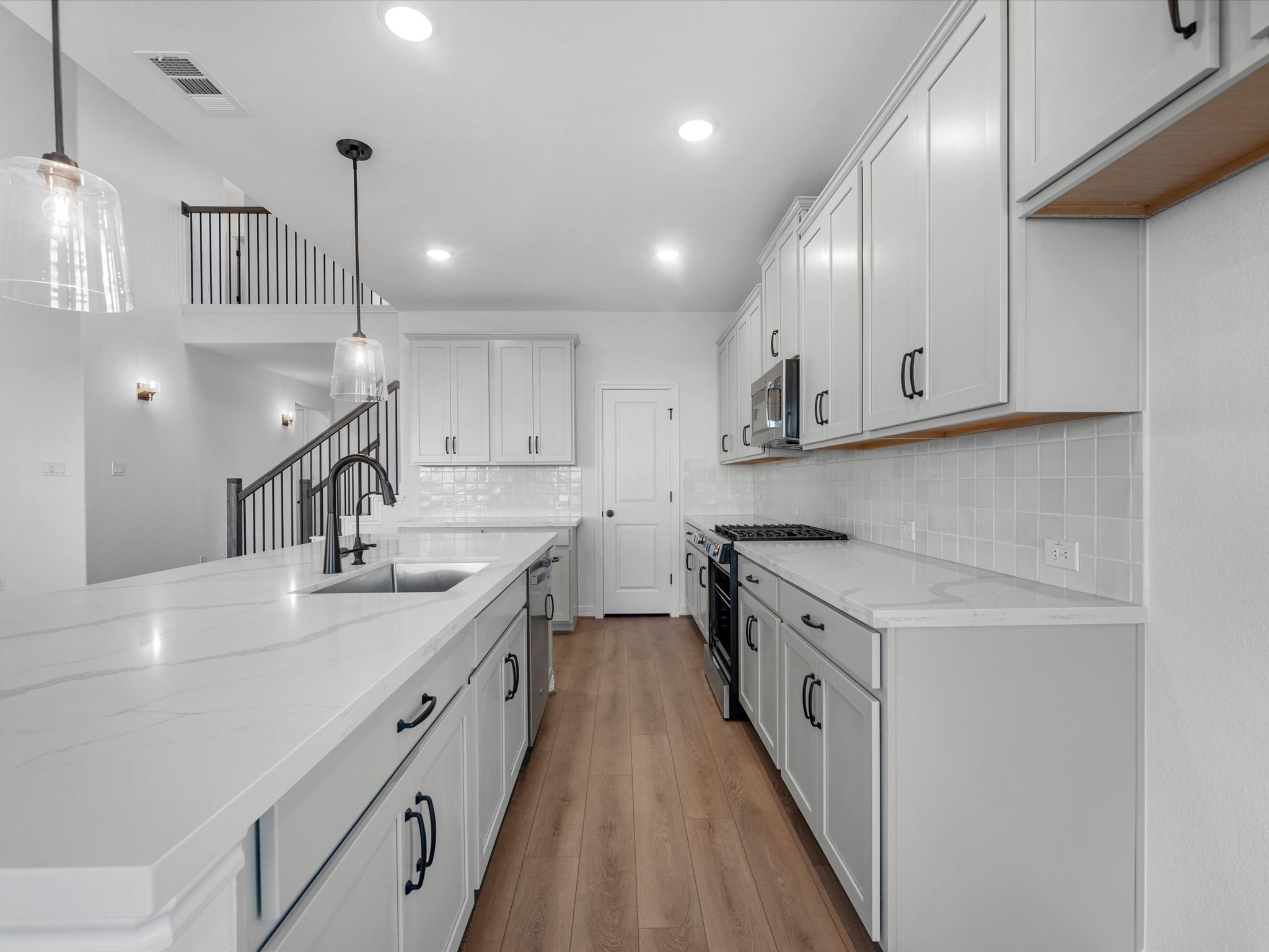 511 Selaura Street Rosenberg, TX 77471 - Photo 4 of 30 a kitchen with stove cabinets and a sink