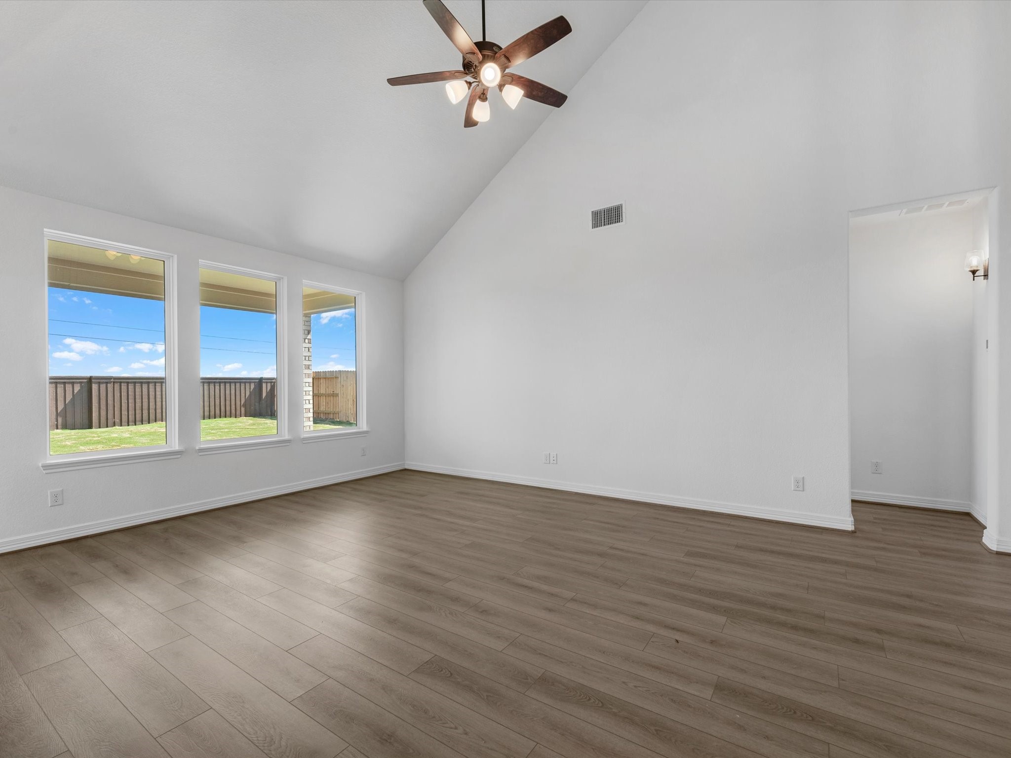 511 Selaura Street Rosenberg, TX 77471 - Photo 8 of 30 a view of an empty room with wooden floor and a window