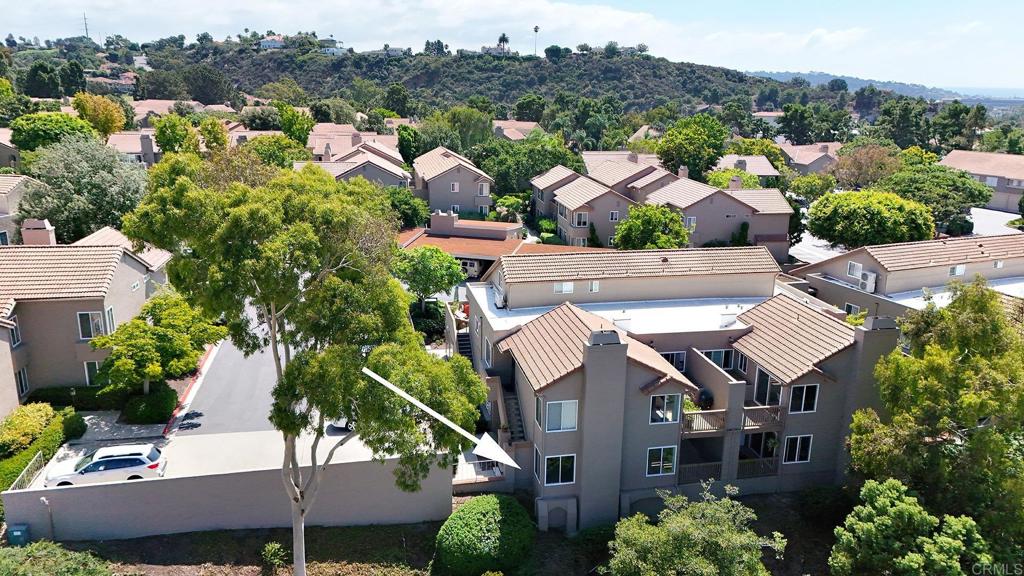 930 Via Mil Cumbres, Unit 52 Solana Beach, CA 92075 - Photo 12 of 34 an aerial view of multiple houses with a yard