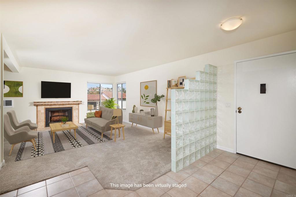 930 Via Mil Cumbres, Unit 52 Solana Beach, CA 92075 - Photo 16 of 34 a view of a livingroom with furniture and a fireplace