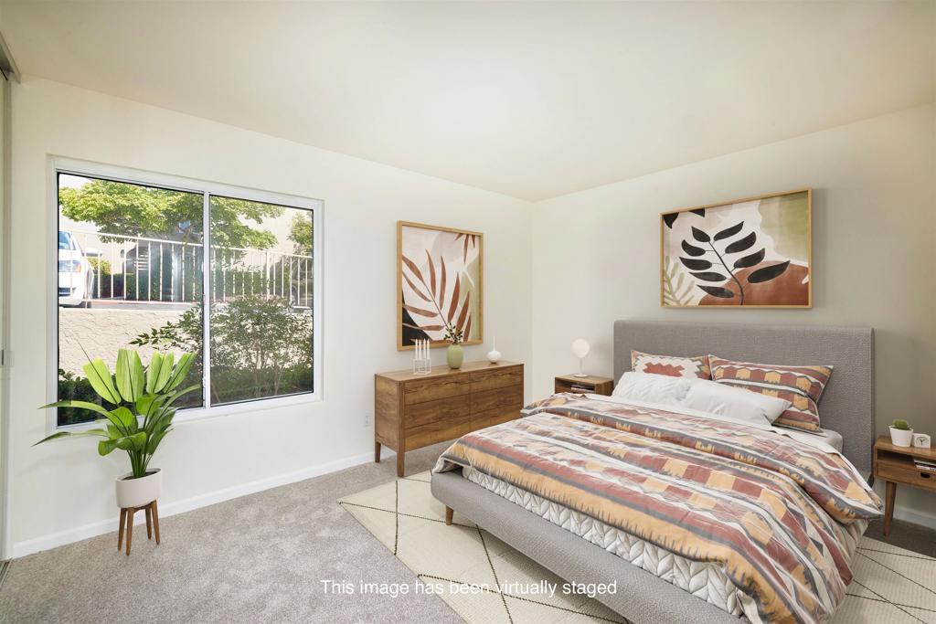 930 Via Mil Cumbres, Unit 52 Solana Beach, CA 92075 - Photo 25 of 34 a bedroom with a bed and a painting on the wall