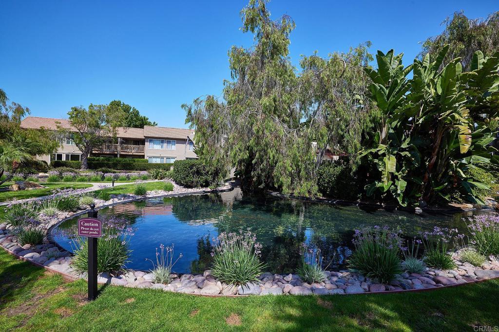 930 Via Mil Cumbres, Unit 52 Solana Beach, CA 92075 - Photo 4 of 34 a view of a house with a garden and swimming pool