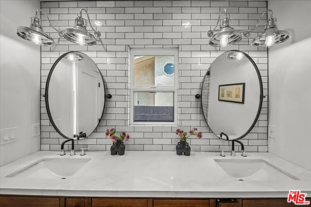 a living room with furniture a rug a table and a potted plant
