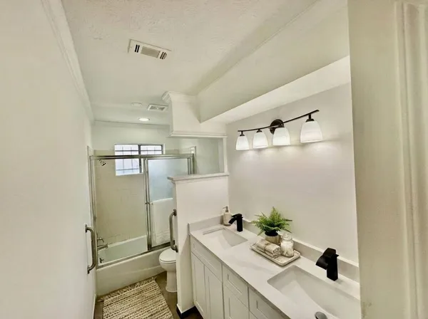 a view of a kitchen with a sink and a refrigerator