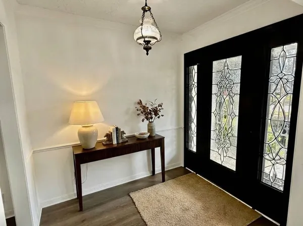 a view of an entryway with wooden floor