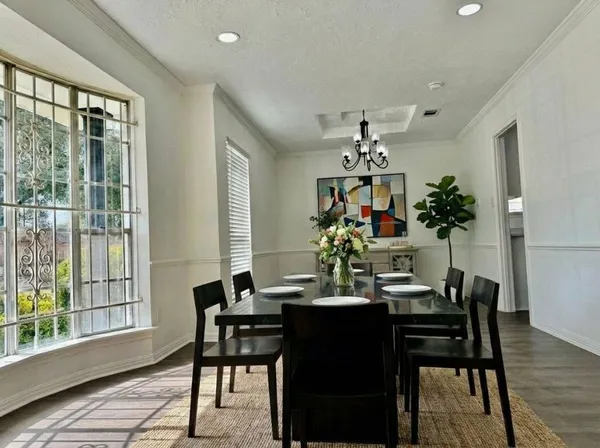 a living room with furniture kitchen view and a flat screen tv