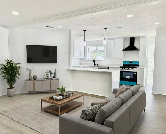 a kitchen with stainless steel appliances granite countertop a table chairs sink and stove top oven