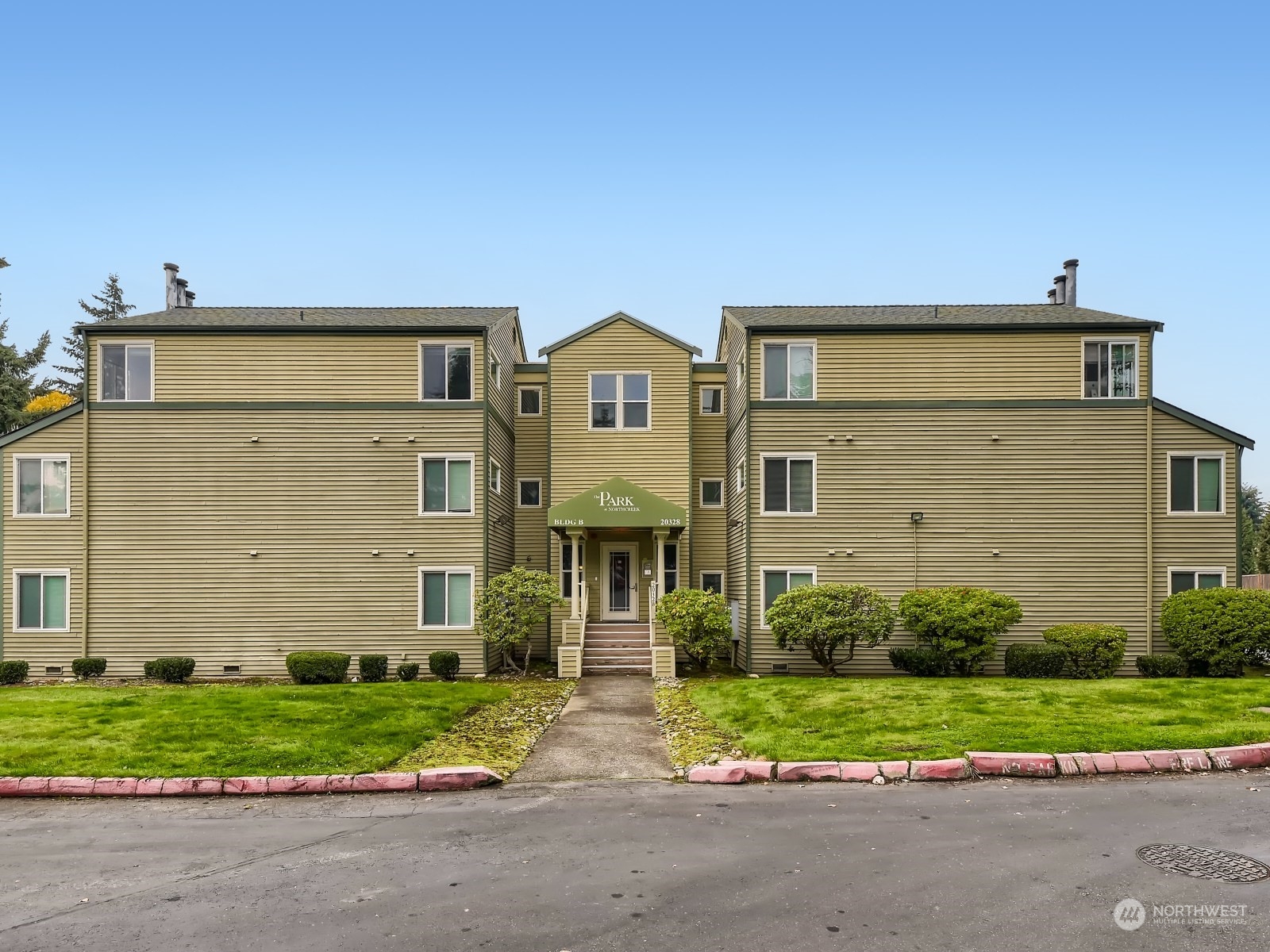 20328 Bothell Everett Highway, Unit B304 Bothell, WA 98012 - Photo 1 of 27 a front view of a house with a yard and garage