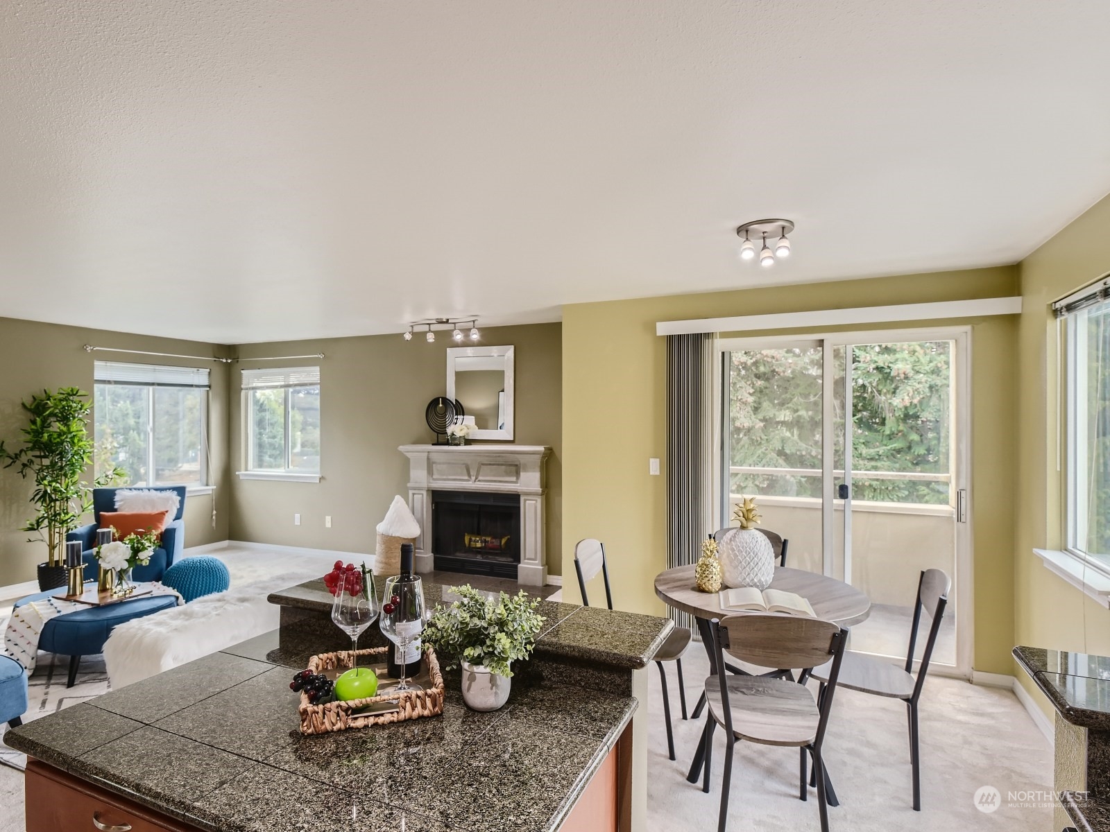 20328 Bothell Everett Highway, Unit B304 Bothell, WA 98012 - Photo 11 of 27 a living room with furniture a fireplace and a floor to ceiling window