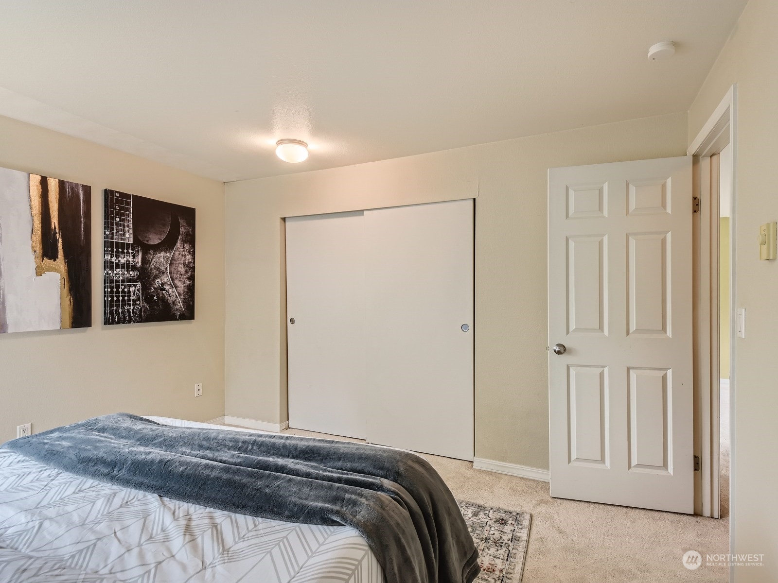20328 Bothell Everett Highway, Unit B304 Bothell, WA 98012 - Photo 16 of 27 a bedroom with a bed and a painting on the wall