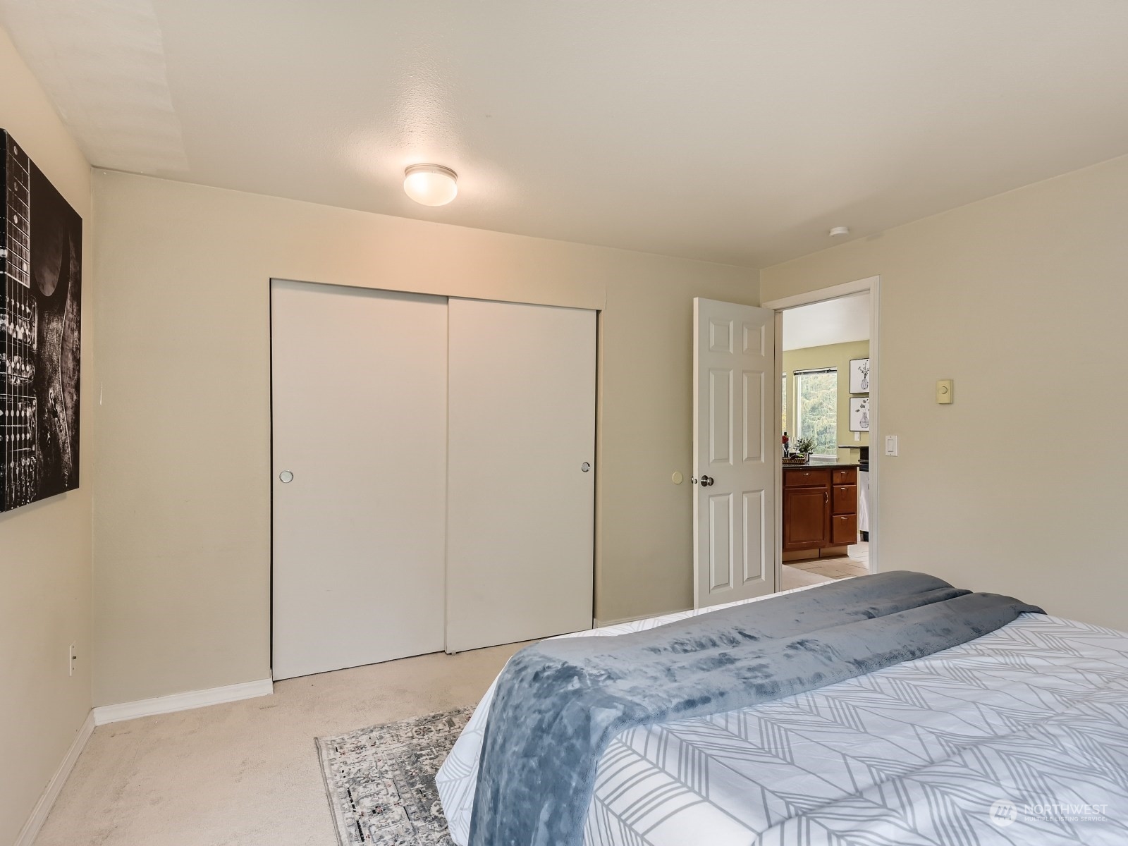 20328 Bothell Everett Highway, Unit B304 Bothell, WA 98012 - Photo 18 of 27 a bedroom with a bed and a mirror
