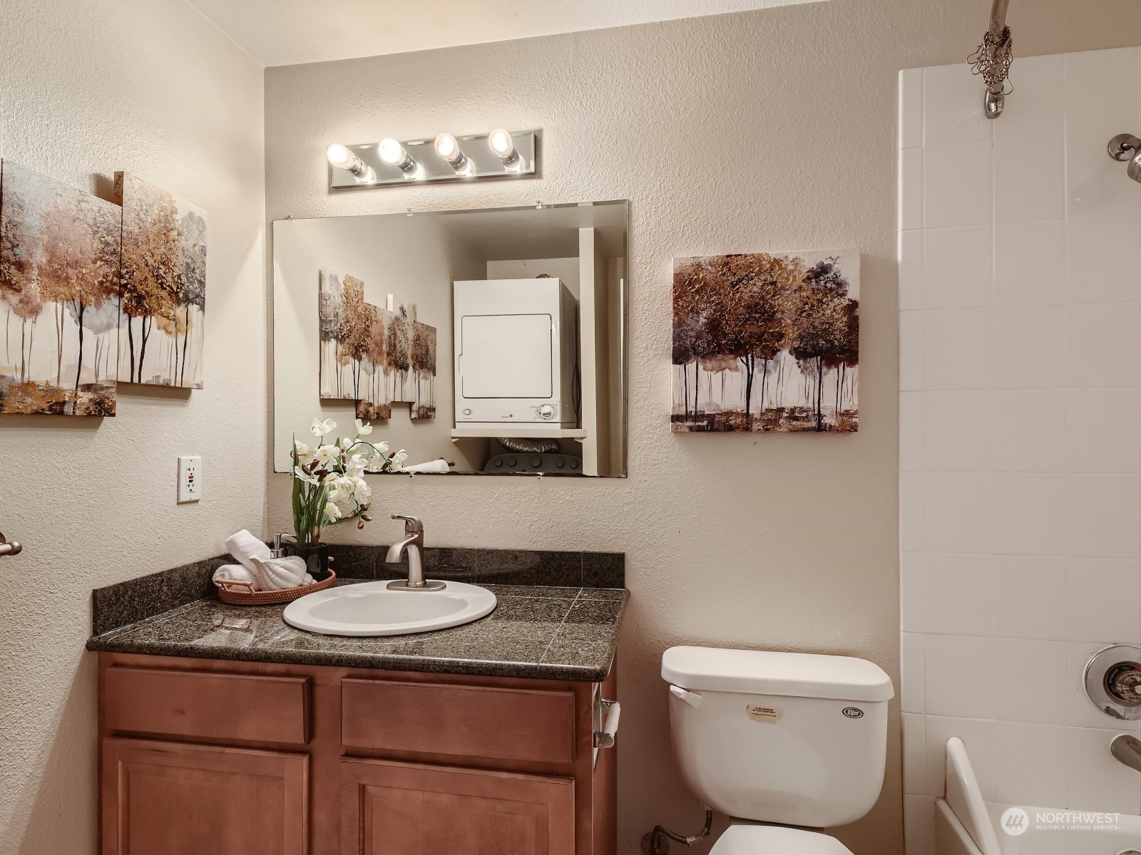 20328 Bothell Everett Highway, Unit B304 Bothell, WA 98012 - Photo 19 of 27 a bathroom with a toilet a sink and mirror
