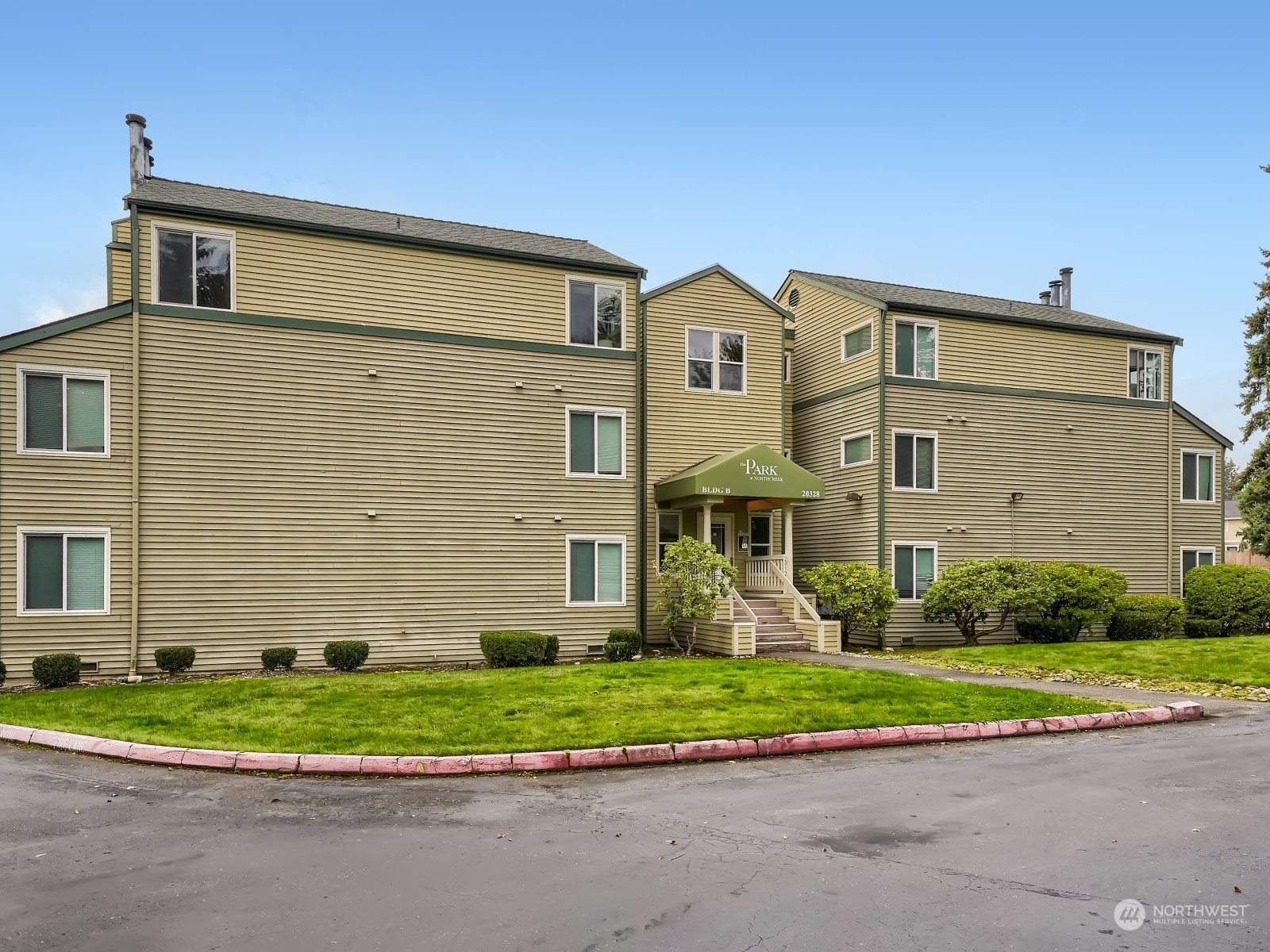 20328 Bothell Everett Highway, Unit B304 Bothell, WA 98012 - Photo 2 of 27 a front view of a house with a yard and plants