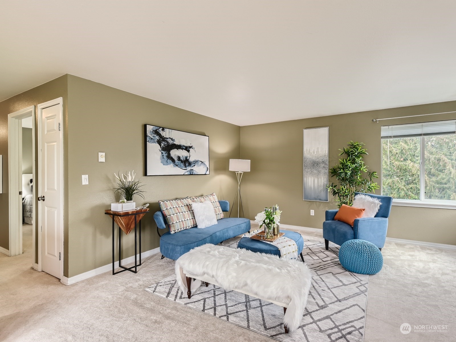 20328 Bothell Everett Highway, Unit B304 Bothell, WA 98012 - Photo 5 of 27 a living room with furniture and a potted plant