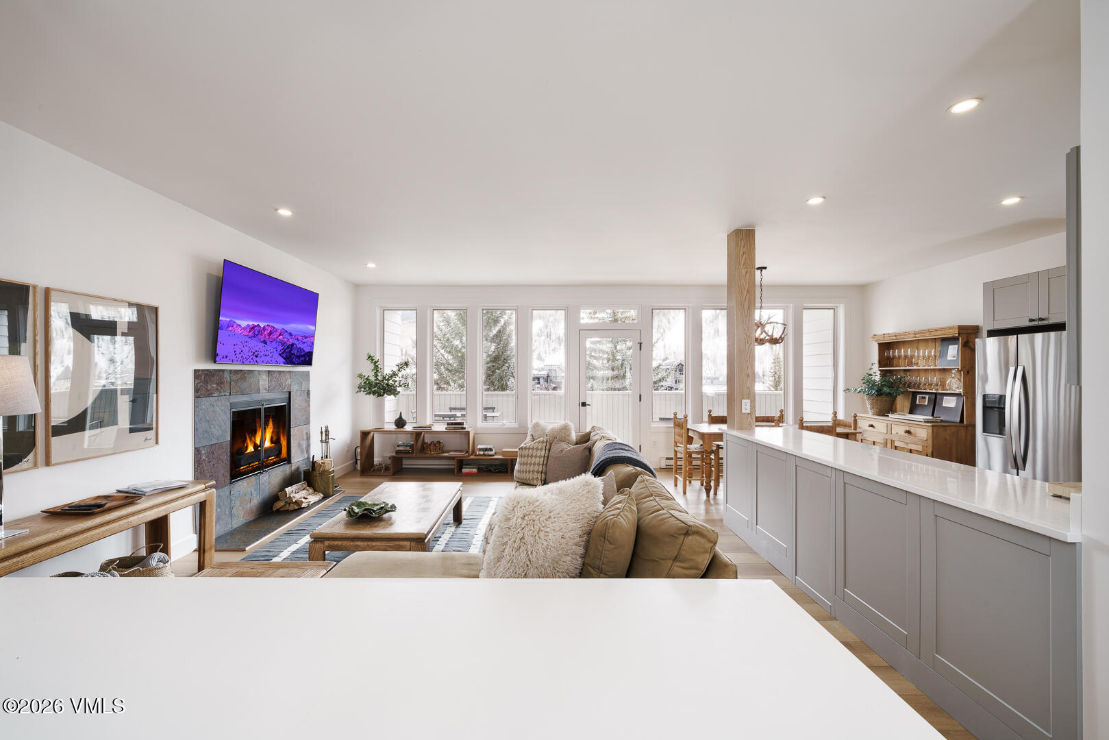 625 North Frontage Road West, Unit 32B Vail, CO 81657 - Photo 2 of 34 a large living room with stainless steel appliances kitchen island granite countertop a large window and a couch
