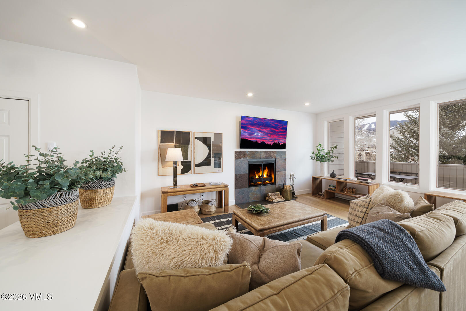 625 North Frontage Road West, Unit 32B Vail, CO 81657 - Photo 4 of 34 a living room with furniture a fireplace and a potted plant