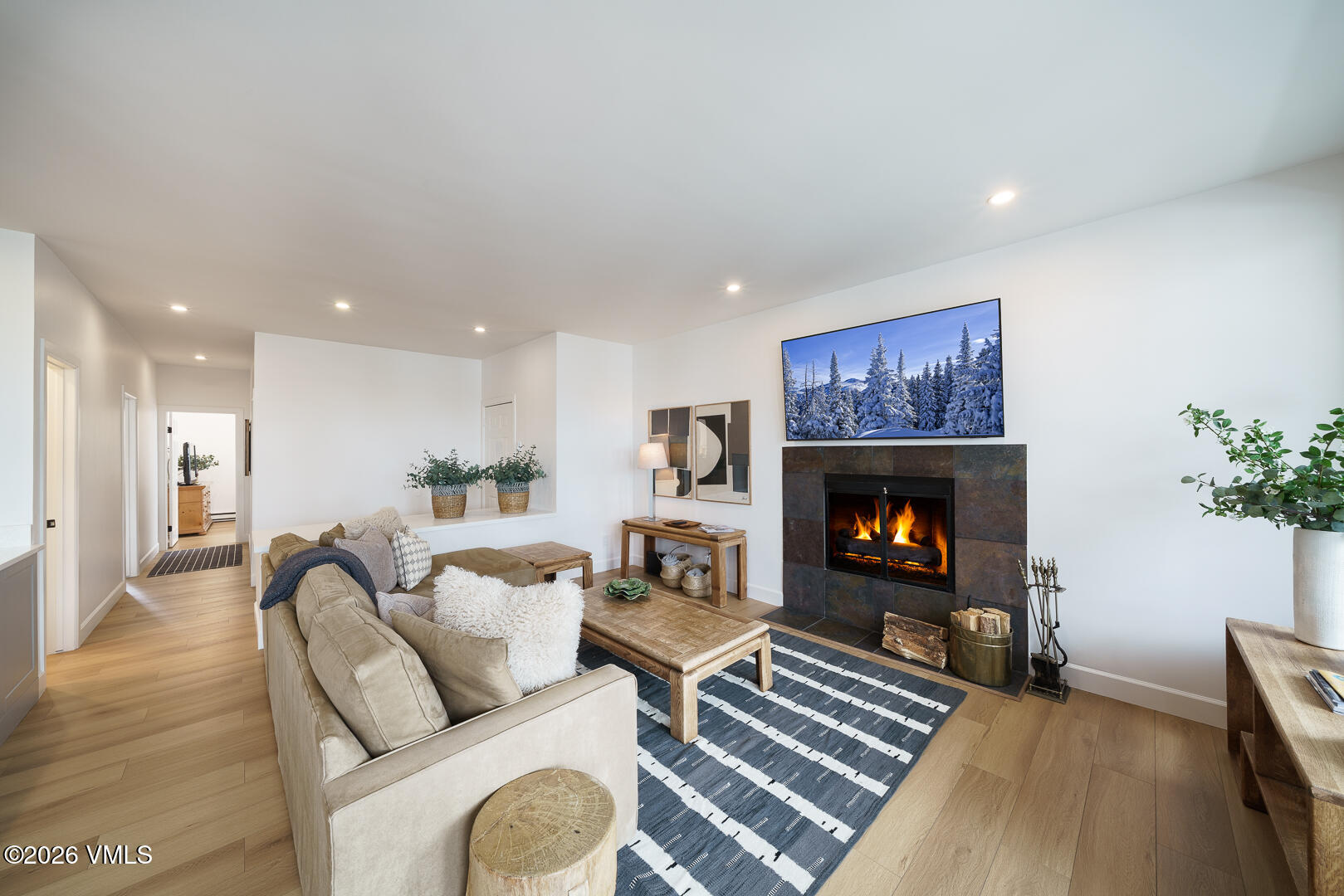 625 North Frontage Road West, Unit 32B Vail, CO 81657 - Photo 6 of 34 a living room with furniture a flat screen tv and a fireplace