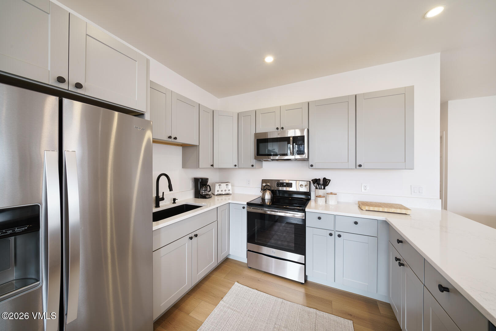 625 North Frontage Road West, Unit 32B Vail, CO 81657 - Photo 8 of 34 a kitchen with white cabinets stainless steel appliances and a sink