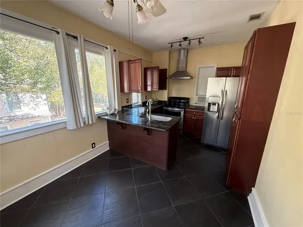 a kitchen with refrigerator and window