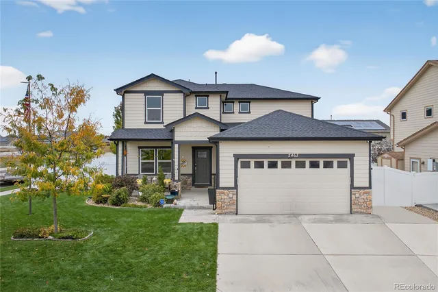 a front view of a house with a yard and a garage