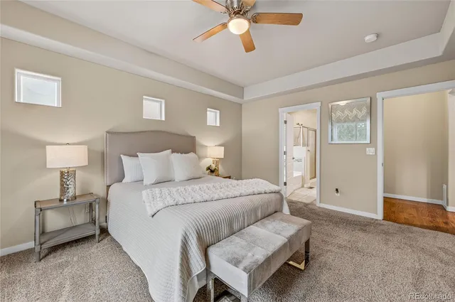 a spacious bedroom with a bed and a chandelier