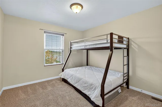 a bathroom with a granite countertop sink a toilet a mirror a bathtub and shower