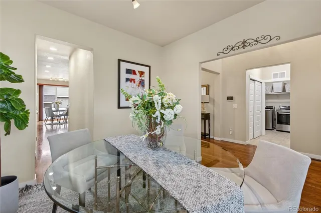 a dining room with furniture and wooden floor