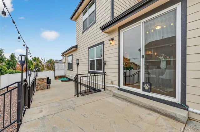 an aerial view of a house with a garden and lake view
