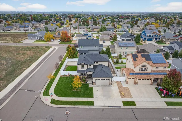 an aerial view of multiple houses with yard