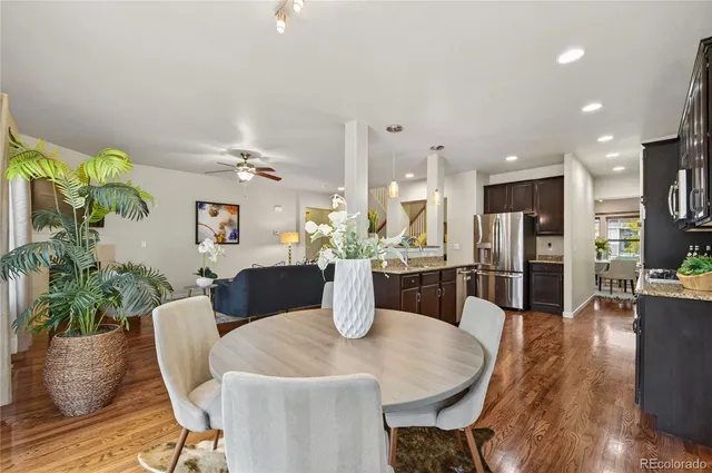 a dining room with furniture and wooden floor