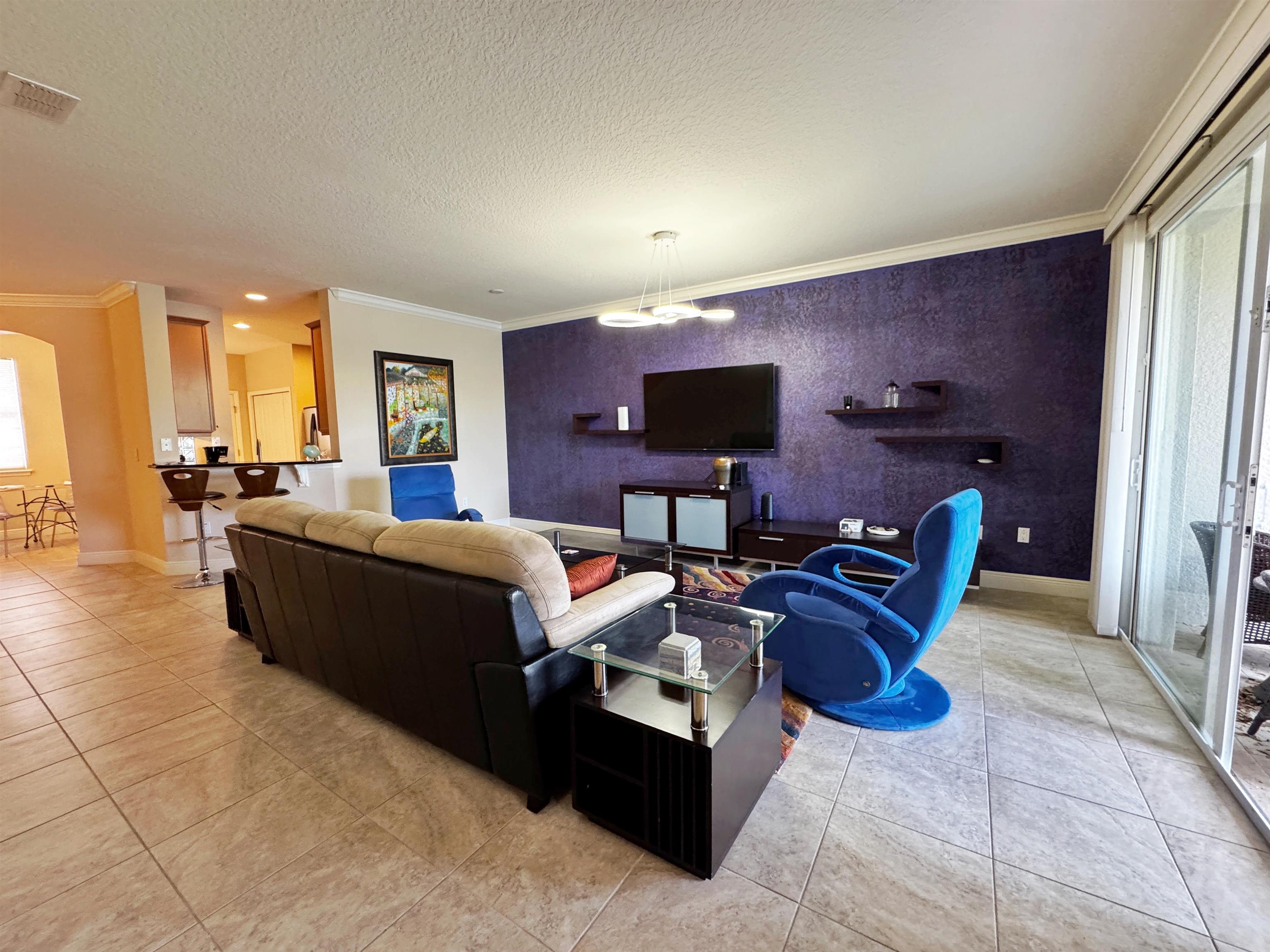 80 Riverview Bend South, Unit 814 Palm Coast, FL 32137 - Photo 12 of 39 a living room with furniture and a flat screen tv