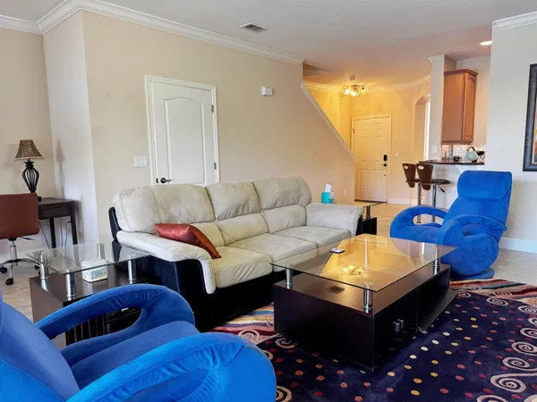 a living room with furniture a rug and a chandelier