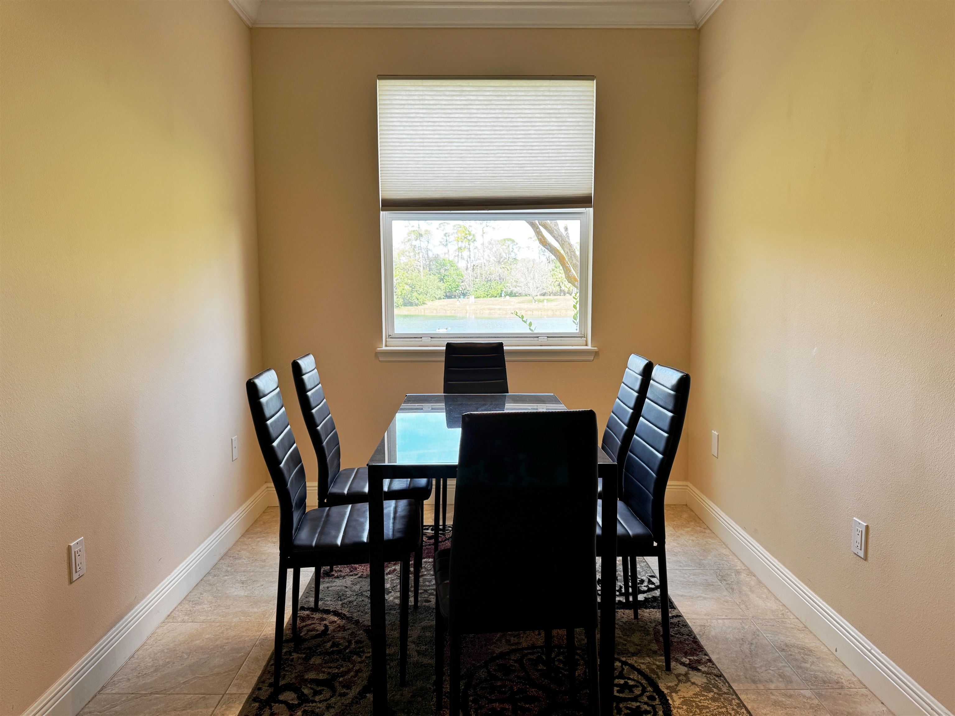 80 Riverview Bend South, Unit 814 Palm Coast, FL 32137 - Photo 15 of 39 a view of a dining room with a table and chairs